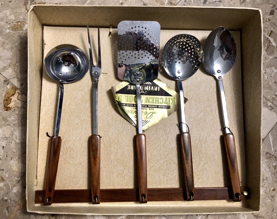 A complete NOS 6-piece Irvin Ware chrome & brown handle kitchen tool set with original rack and box — pristine mid-century American kitchenware that looks like it belongs in a museum display or a dream MCM kitchen.
