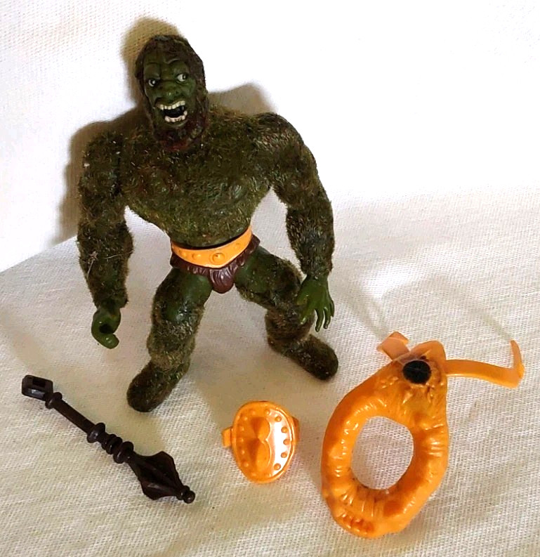 Moss Man is one of the most visually distinct MOTU figures ever made — fuzzy flocked body, pine scent, and full accessories in VG condition from 1985.