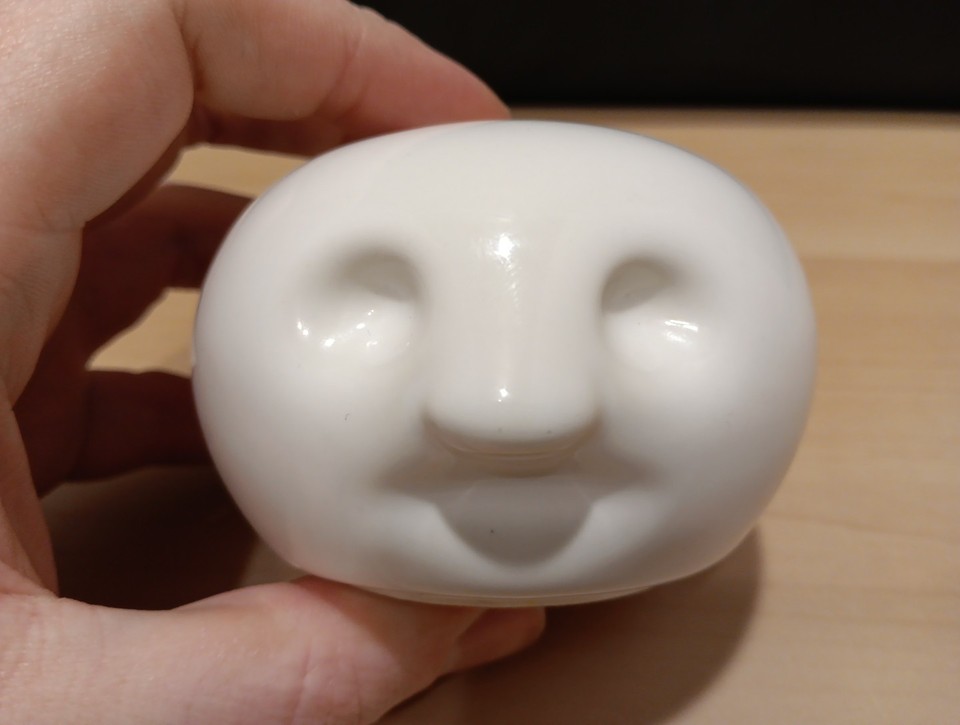 A 1982 corporate paperweight shaped like a boss's head — peak 80s office satire as an actual physical artifact.