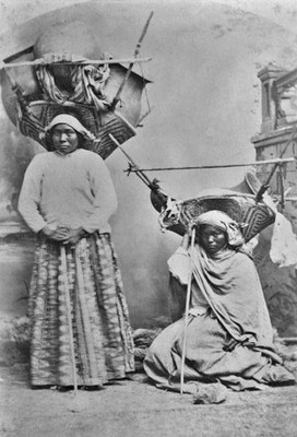 Two Tohono OOdham Women One Standing Other Sits Ground Both Wearin- Old Photo