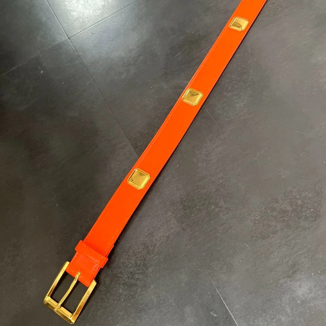Ceinture Christian Dior cuir orange cloutée taille 75 B368