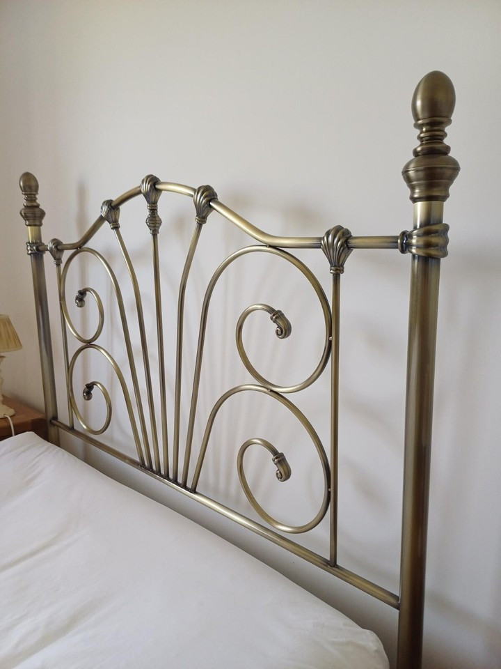 Antique brass effect headboard. Standard double bed. Excellent