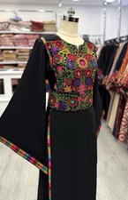 Elegant black long dress with colorful traditional embroidery and waist belt.