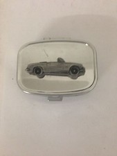 MG B Roadster ref129 pewter effect car emblem on a silver metal pill box