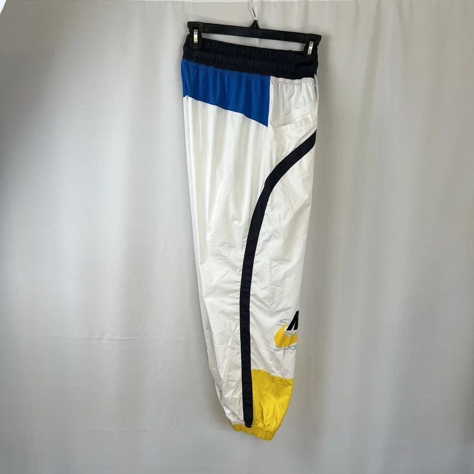 Pantalones deportivos ligeros vintage para niños talla mediana Nike años 90 amarillos Wind Foto 4 de 4