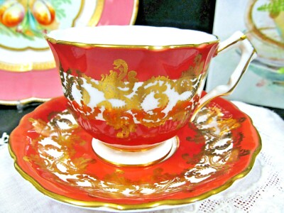 Aynsley tea cup and saucer orange and gold gilt peacock scroll teacup England  