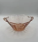 Vintage pink depression glass bowl featuring a scalloped rim 1930s