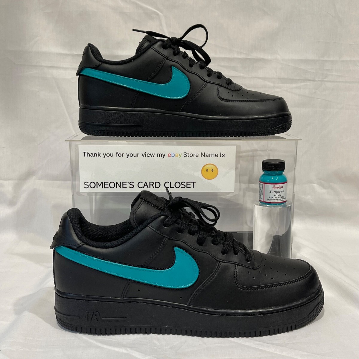 black nike shoes with teal swoosh