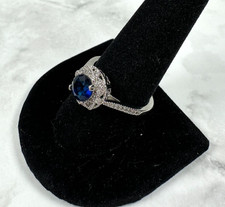 Silver Tone Ring with Blue Round Faceted CZ with Clear CZ Halo - Size 10.25