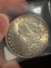 1887 $1 Morgan Silver Dollar in UNC+ Condition Toning