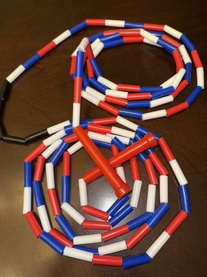 Vintage Red/White/Blue segmented skip/jump rope. Approx. 16  with black center 