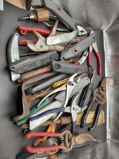 Lot of different tools tin snips knives flashlight plyers