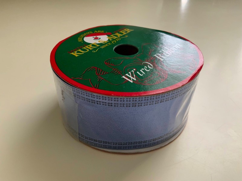 Wired Ribbon Santa’s Kurt Adler Size: 50 ft x 2” Sealed.
