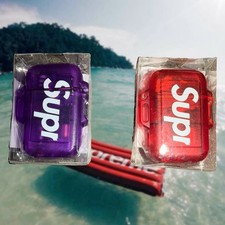 SS26 Red Supreme Japan Windmill Zag Lighter Spell Out