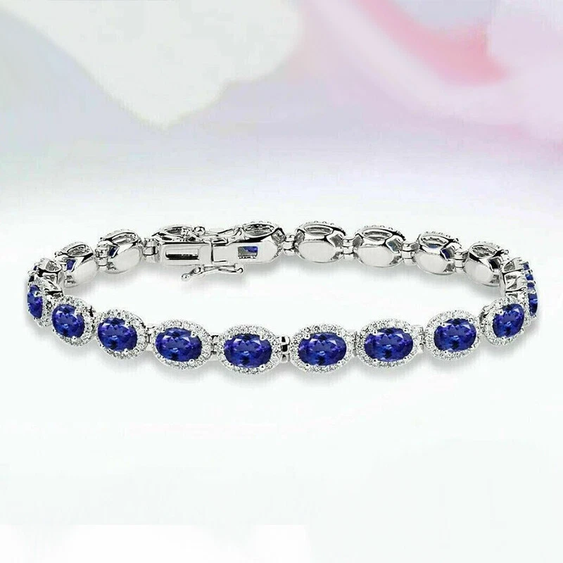 Brazalete de tenis con halo de diamantes de tanzanita azul corte ovalado de 15 quilates acabado en oro blanco de 14 quilates Foto 4 de 4