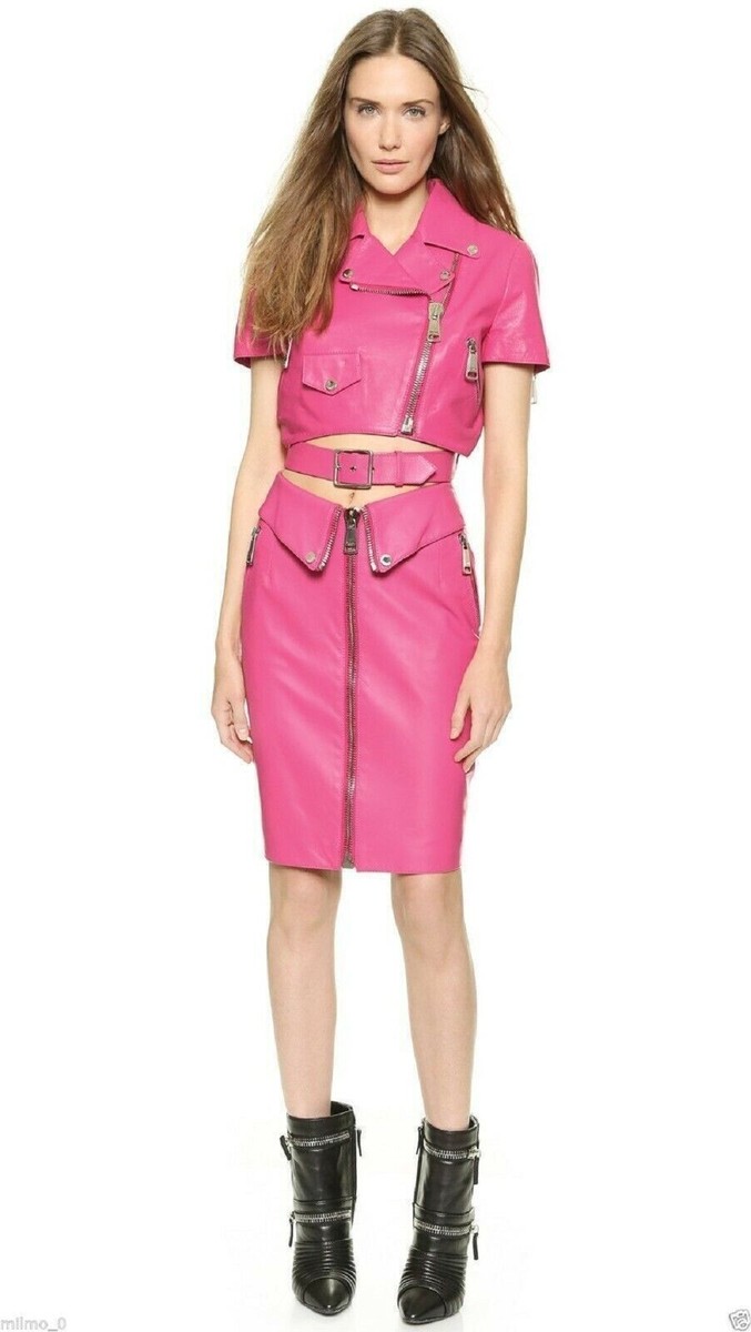 pink dress with black leather jacket Portrait of young woman wearing black leather jacket and pink dress in front of concrete wall stock photo