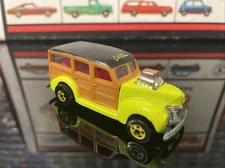 Hot Wheels Cal Custom 40’s Woodie yellow in color with hot pink interior!