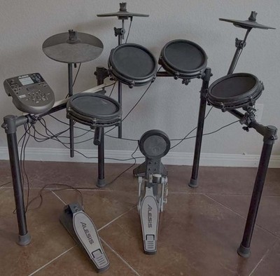 Alesis Nitro Mesh is a complete 8-piece electronic drum kit w/DM7X module Tested
