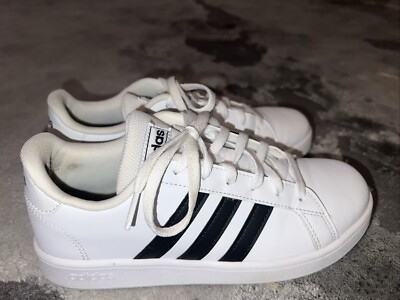 white adidas with black stripes on one side