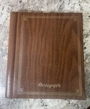 vintage-style photo album with a rich, dark brown wood-grain effect cover