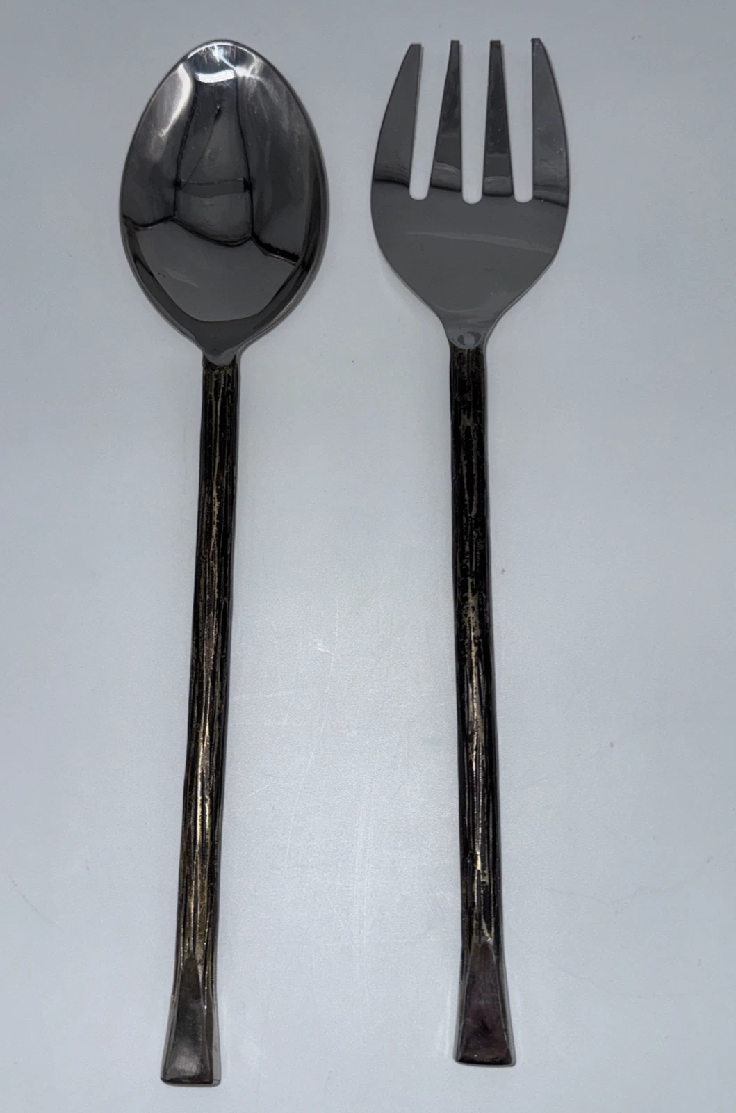Rustic forged stainless steel salad server set. Size: 11 in, 11 oz.