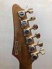 Gold Ibanez AZ47P2K Dragoneyeburst electric guitar with six tuning knobs and silver fretboard, used at the edge of the neck.
