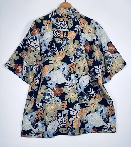 Black Hawaiian shirt men’s 2XL with orange, yellow, and blue floral print, green leaf background, and short sleeves.