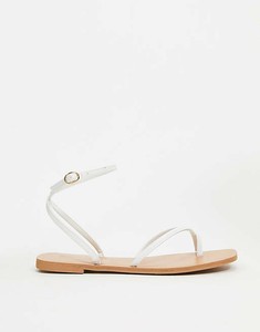 white flat sandals with ankle strap