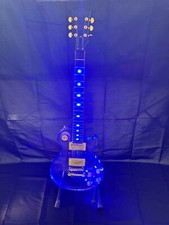 The new LP acrylic electric guitar is surrounded by blue LED lights on the body