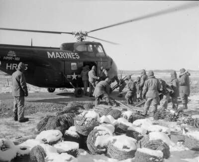 Marine engineers load helicopter here materials make hill top bunke- 1952 Photo