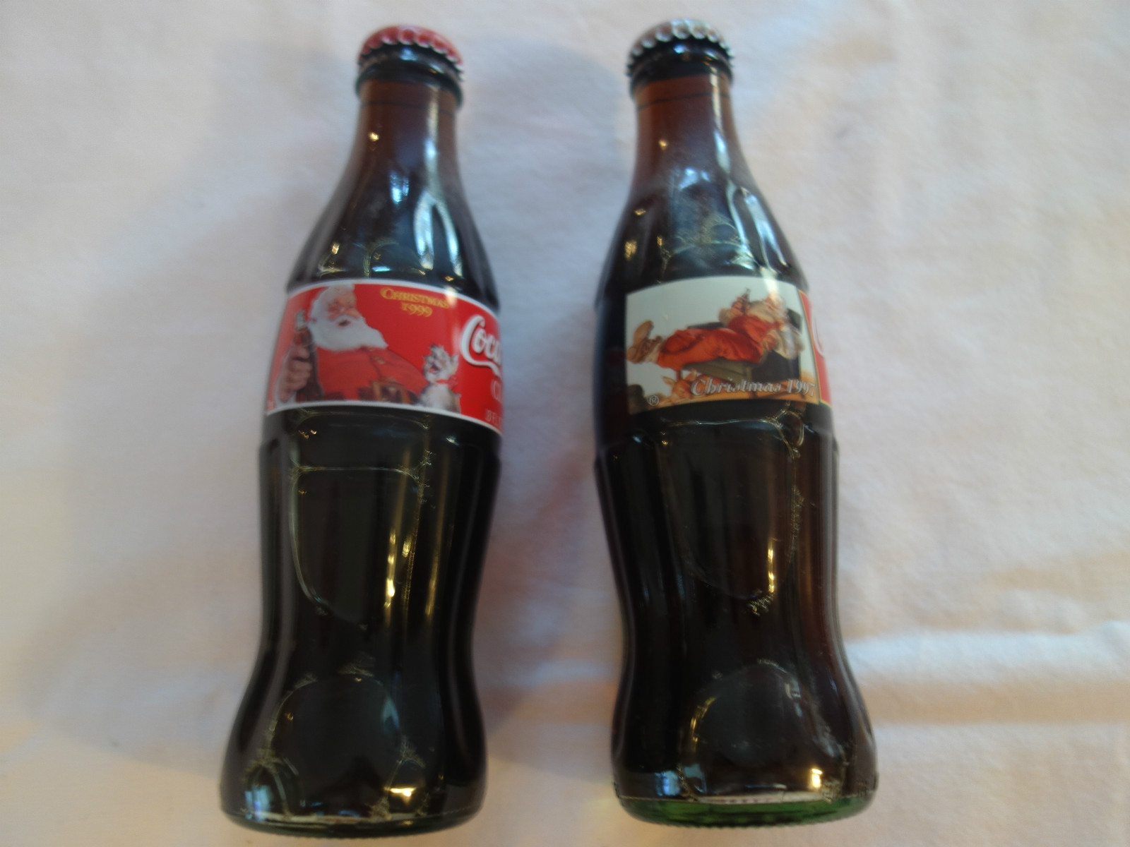 Lot of Two 8 oz Christmas Coke Bottles/Sealed 1997 and 1999 Santa Claus