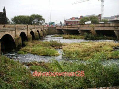 PHOTO  CONTRAST IN STYLES TO THE LEFT IS WAKEFIELDS MEDIEVAL BRIDGE WITH THE CHA