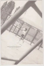 Through the Net - A Dynamic Shot of Young Athlete in Action on the Tennis Court