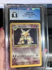 1999 WOTC Pokemon Base Set Alakazam 1/102 Unlimited Holo TCG CGC 8.5 NM/MINT+