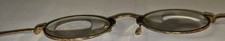 Vintage gold finish eye glasses with unusual ear piece.
