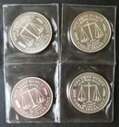 Four 1986 1oz Silver World Trade Unit Rounds in Plastic