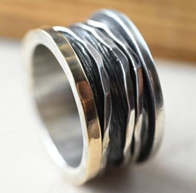 Two-tone rotating ring ''Noga'' with three wave-shaped outer rings