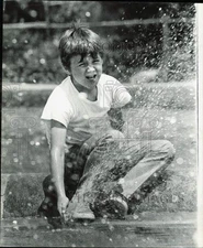 1970 Press Photo A little boy playing with water on a spring day in Chicago
