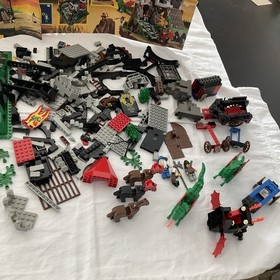 Lego Parts From Sets 6082 And 6056, Including Some Minifigs, Horses,and Dragons.