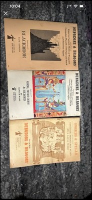 three vintage Original Dungeons & Dragons (OD&D) supplemental rulebooks