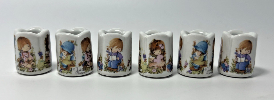 A set of 6 West German mini candle holders with quirky Jaklien Lannoo comic art — obscure mid-century European collectibles that are genuinely hard to find.