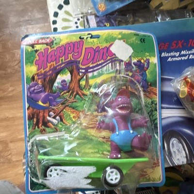 Happy Dino pull back skateboard. Barney bootleg. The bubble is falling off