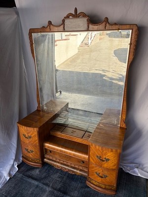 Vintage 1930s Art Deco waterfall vanity with a large carved mirror on casters