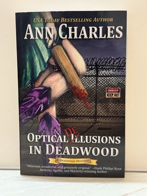 OPTICAL DELUSIONS IN DEADWOOD (DEADWOOD HUMOROUS MYSTERY) By Ann Charles **NEW**