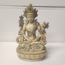 Statue divinité bouddhiste assise figurine sur socle lotus avec fleurs de lotus bouddhisme