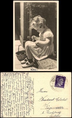 Girl eating cherry with basket on a stone step 1941