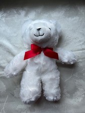 white plush teddy bear with red bow stuffed toy