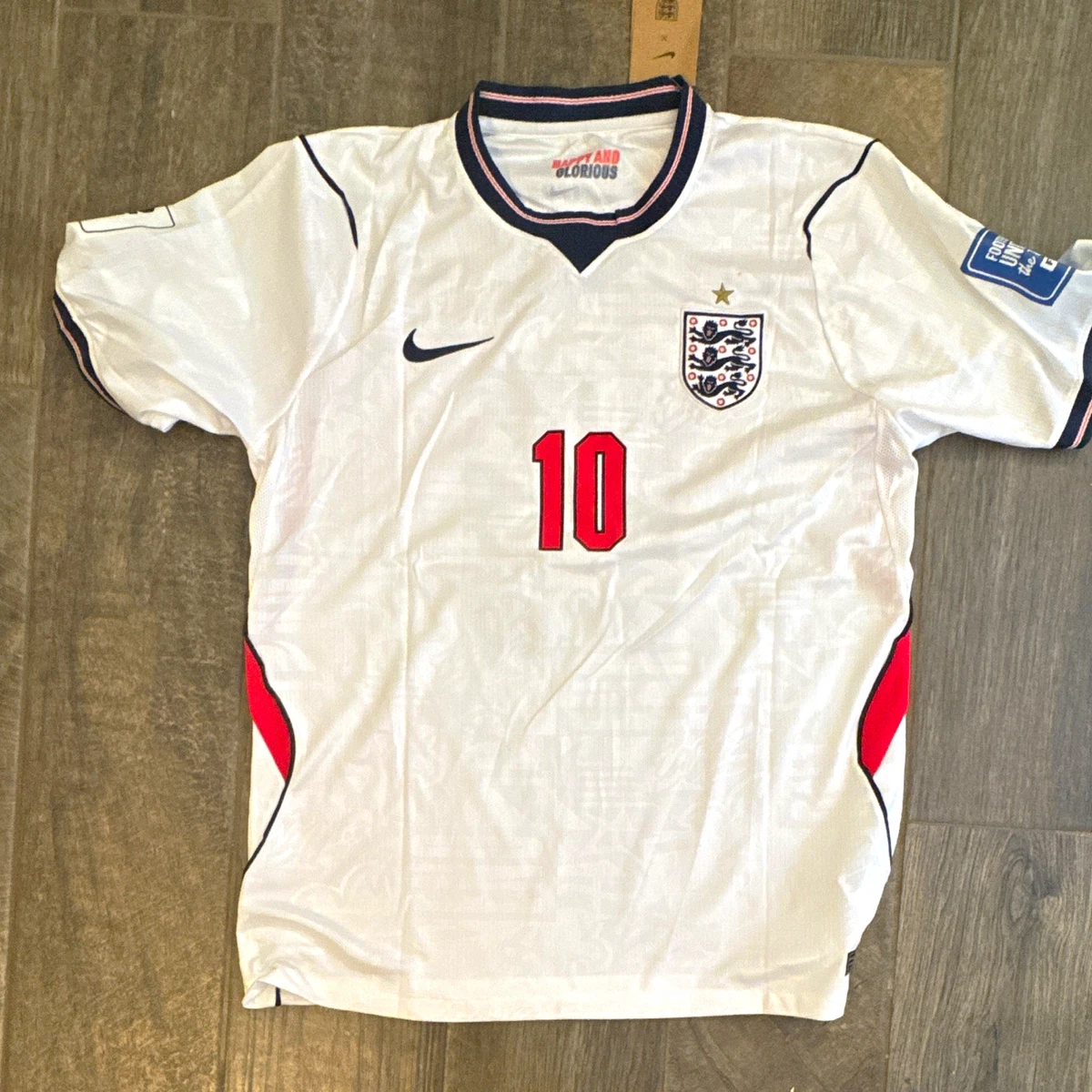 Preços baixos em Equipe Nacional Nike Inglaterra Branco Roupas e