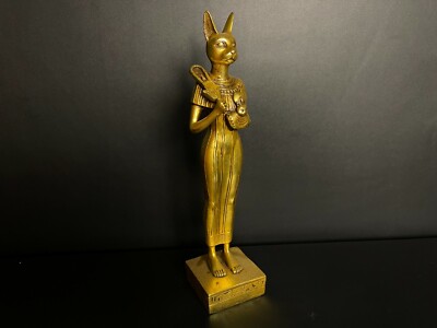 Egyptian cat Bastet goddess of protection holding Hathor's sistrum and Sekhmet