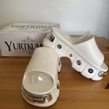 White clogs with silver studs and logo accents, chunky slip-on design Size 37-38
